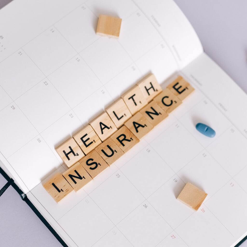titles with letters on them that spell out "health insurance"