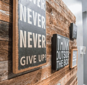 a sign inside of a teen treatment center in dallas texas that reads "never never give up"