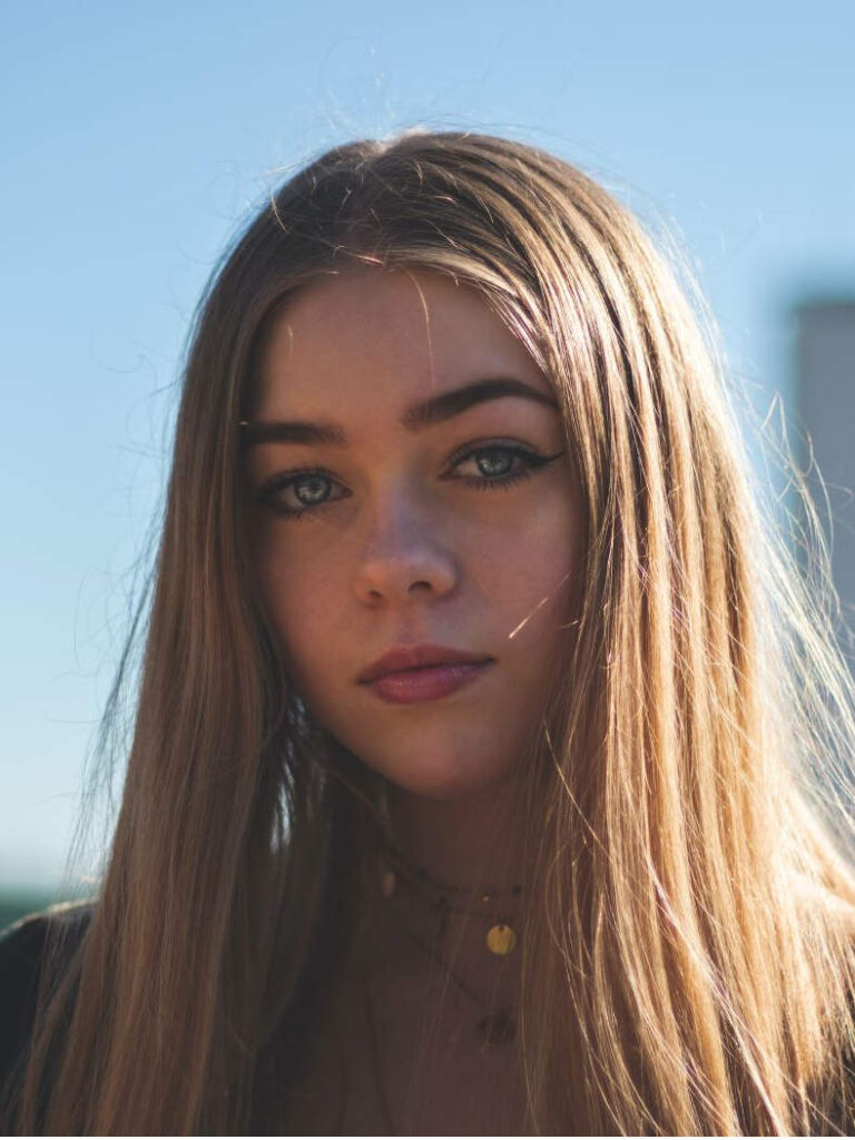 headshot of young girl happy about dealing with addiction issues as a teenager