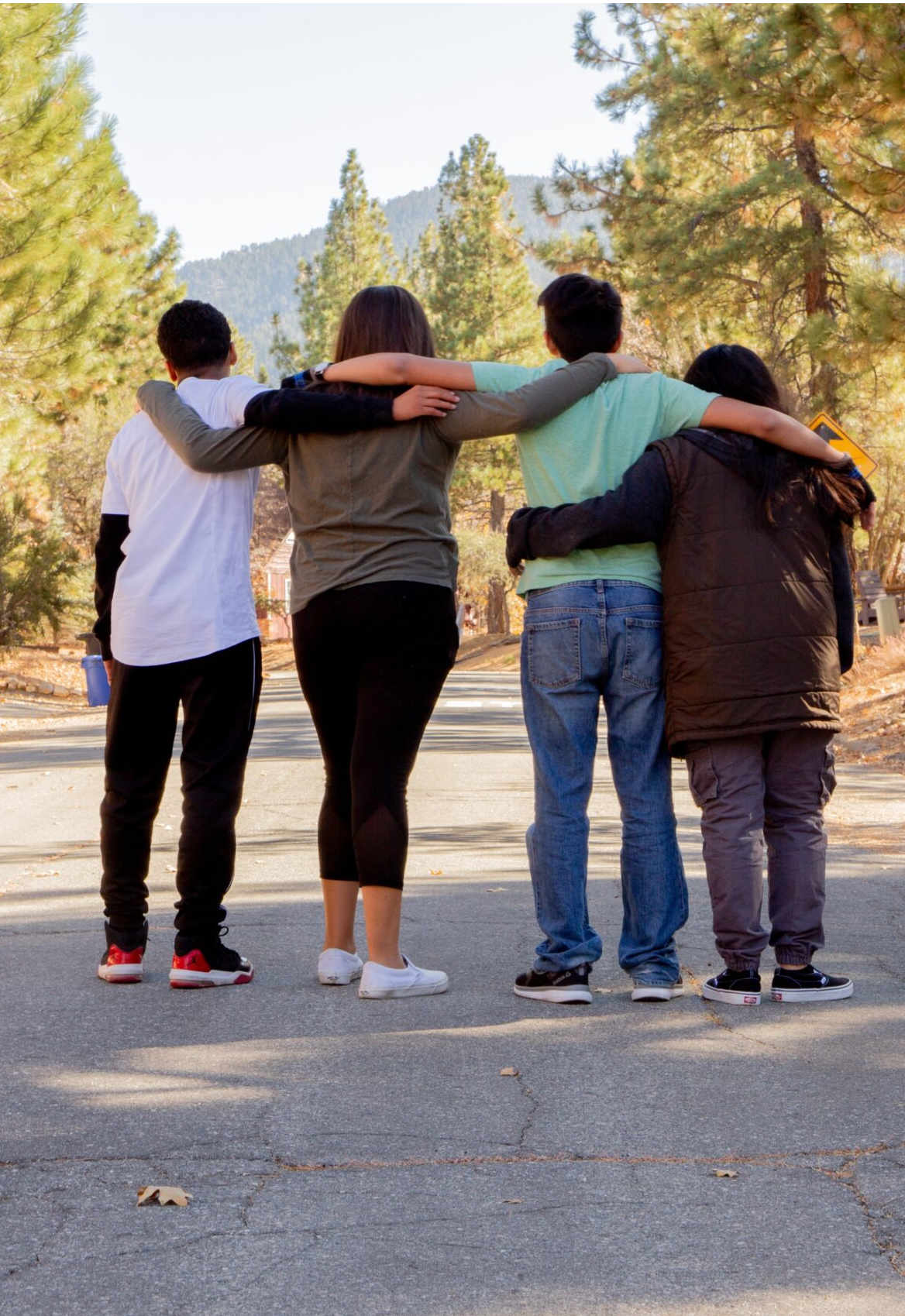 four teens hugging each other