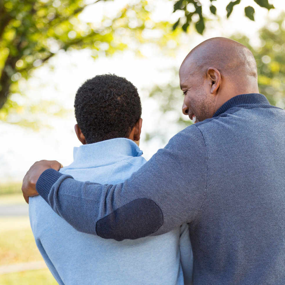 father and son hug each other after a successful treatment plan