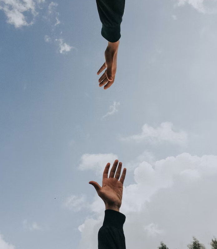 hands reaching for each other in a supportive way