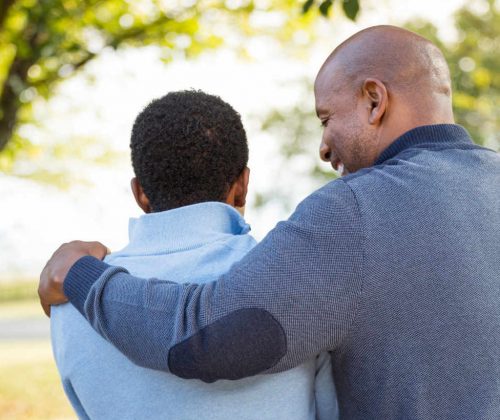 father and son hug each other after a successful treatment plan