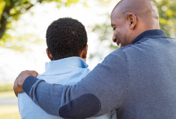 father and son hug each other after a successful treatment plan