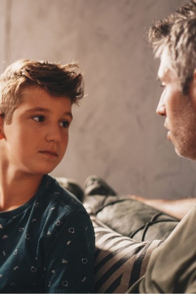 An adolescent boy and his father have a heartfelt conversation