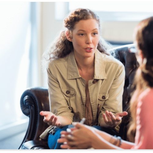 Female counselor speaking to a teen.