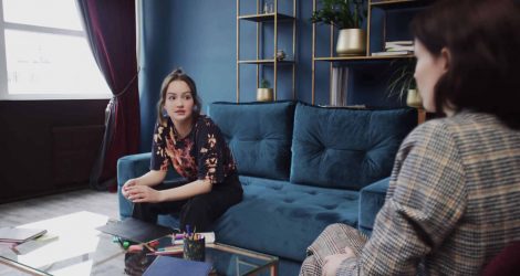 Teen girl talking to a mental health therapist at a treatment center