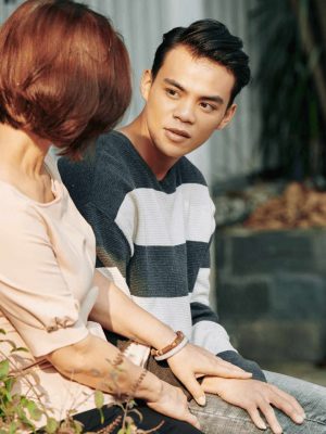 Mother and young teenage son outdoors having a serious conversation about mental health for teens