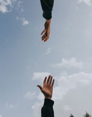 hands reaching for each other in a supportive way