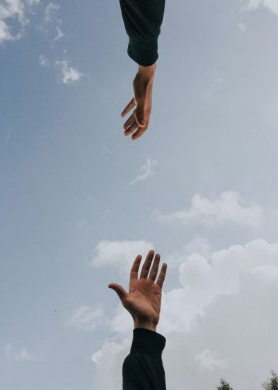 hands reaching for each other in a supportive way