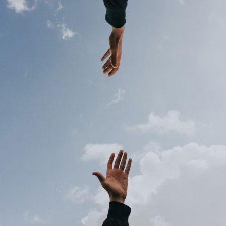 hands reaching for each other in a supportive way