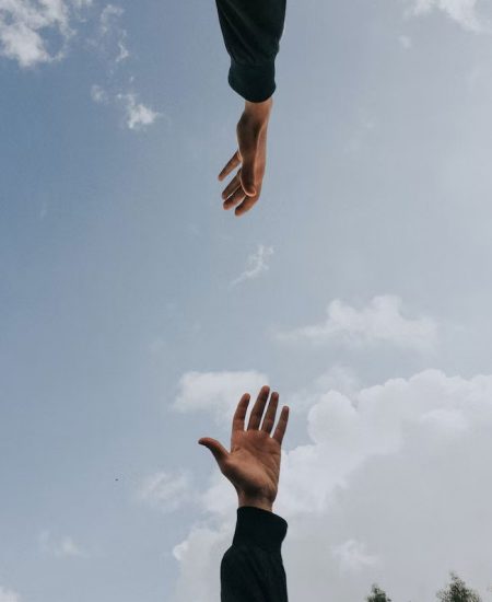 hands reaching for each other in a supportive way