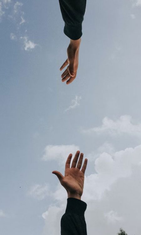 hands reaching for each other in a supportive way