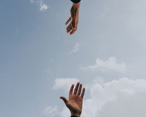 hands reaching for each other in a supportive way