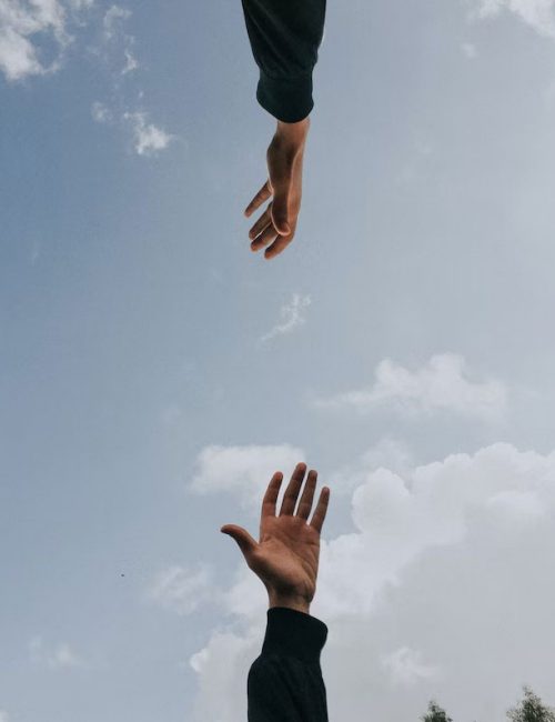 hands reaching for each other in a supportive way