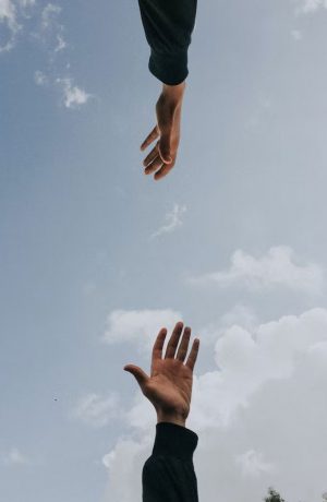 hands reaching for each other in a supportive way