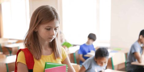 sad young teen girl at school dealing with the pressures of anxiety and depression