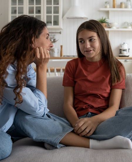 A mom listens as her adolescent daughter talks about a problem