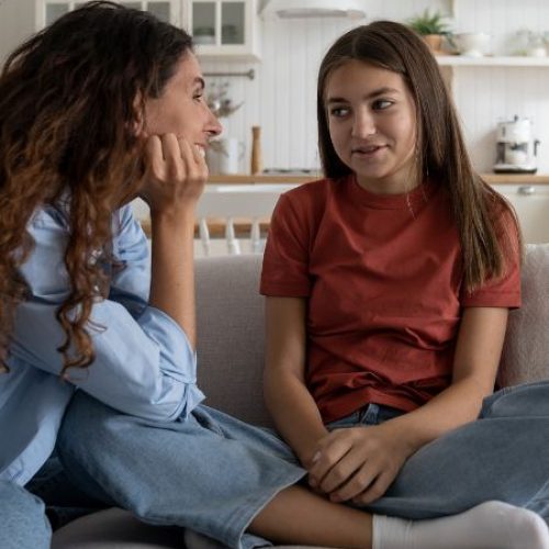 A mom listens as her adolescent daughter talks about a problem