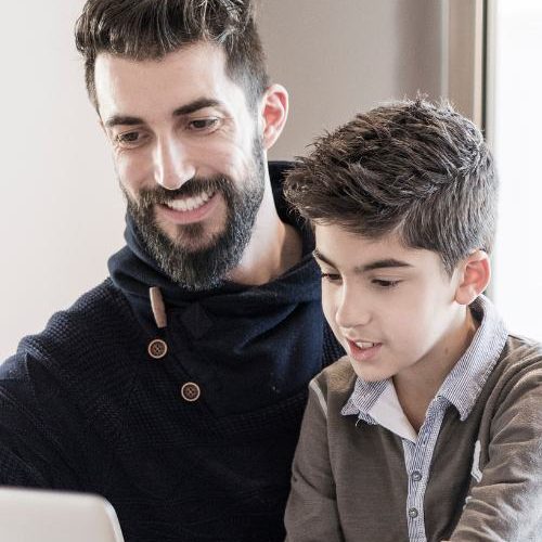 A father and son talk to a mental health therapist online