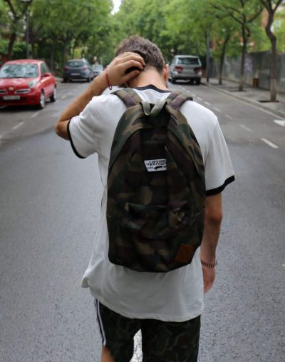 Young boy walking in the middle the road dealing with mental health issues as a teenagers