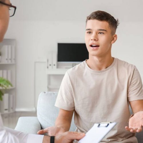 Teen boy talking to a mental health therapist/psychotherapist