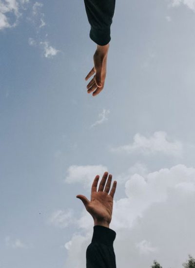 two hands reaching for each other