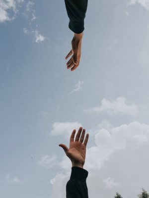 two hands reaching for each other