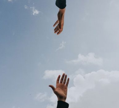 two hands reaching for each other