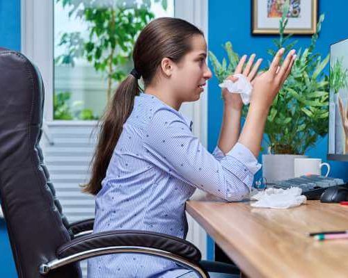 Teen girl crying while talking to an online therapist